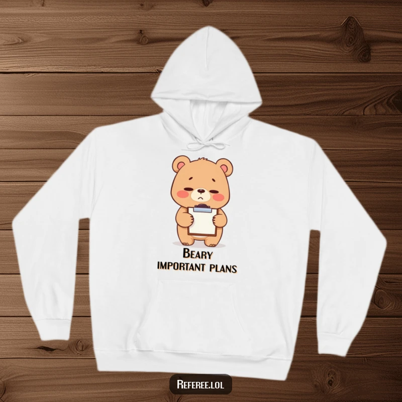 Funny hoodie showcasing a giggling bear with a stern but sweet expression, tapping a tiny clipboard, perfect for mock-serious office charm.
